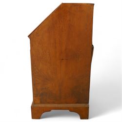 18th century walnut and herringbone banded bureau, the fall front enclosing a stepped and arched interior fitted with pigeonholes, drawers and concealed compartments, green tooled leather writing surface, over two short and three long graduated drawers with brass escutcheons and bail handles, shaped bracket feet