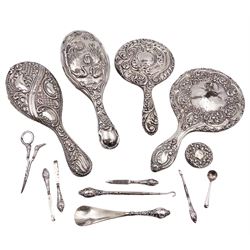 Group of silver mounted dressing table items, including two hand mirrors, two hairbrushes and a part manicure set, etc all with varying designs, all hallmarked