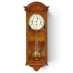 Comitti of London - burr walnut three-train wall clock, the circular dial with Roman numerals, glazed case revealing the movement and brass pendulum