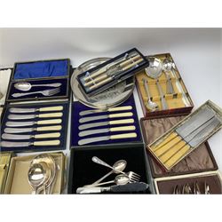 Silver plated decorative tray D20.5cm, together with a collection of flatware including three sets of cased butter knives, Community  cutlery teaspoons, spoons, knives etc. 