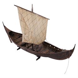 Three wooden model ships, comprising a single mast Schooner style pond yacht, a kit-built Viking longship and a model of HMS Endeavor, Schooner H117cm