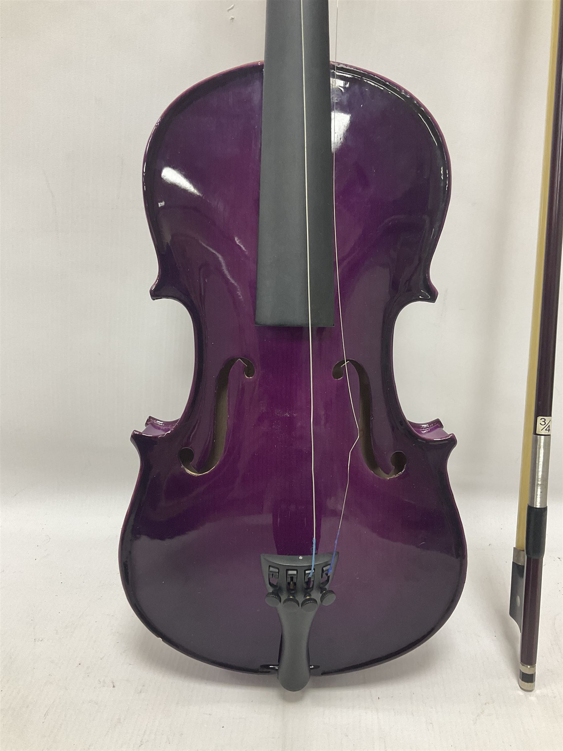 Intermusic 3/4 violin with a violet coloured solid wood body, ebonised fingerboard and fittings, bow and hard case, length 54cm