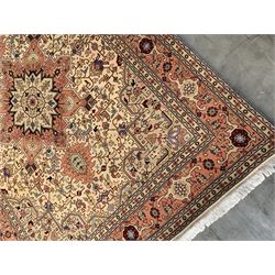 Fine Persian Tabriz rug, ivory and peach ground, central medallion surround by interlacing geometric foliage an decorated with stylised flower heads, repeating boarder with guards 