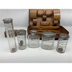 Mappin & Webb leather cased campaign gentleman's vanity set, the tan leather case opening to reveal fitted interior with five engine turned silver capped glass vanity bottles, hallmarked Mappin & Webb, London 1944, brushes, mirror etc, monogram DPK to the top of the case