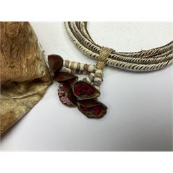 Collection of traditional necklaces from the Solomon Islands, including shell and boar tusk examples, together with a carved canoe prow, with mother of pearl eyes, painted cow hide and a copper plaque, depicting the Solomon Islands, with presentation engraving