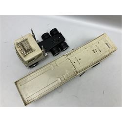 American Nylint large scale tin-plate car transporter L59cm carrying a Testor Toys plastic car; Tonka tin-plate mobile crane; boxed Sarony Cigarettes tin-plate roulette game with rules; and Japanese style tin-plate box, the lid inset with a revolving poker dice game (4)