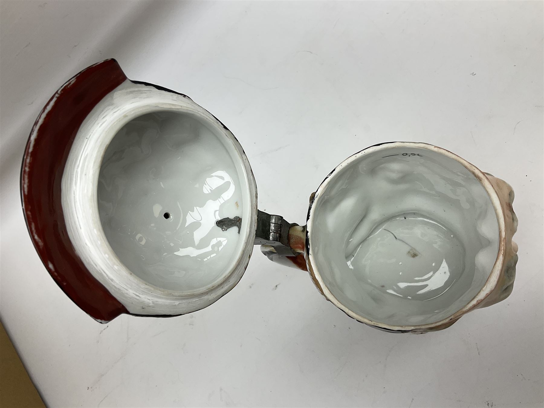 Otto Von Bismarck figural 0.5l stein, his black pickelhaube helmet with chrome spike serving as the lid, in green uniform and gilt detail throughout, pewter thumb hinge, with blue hash Musterschutz type mark, H18cm