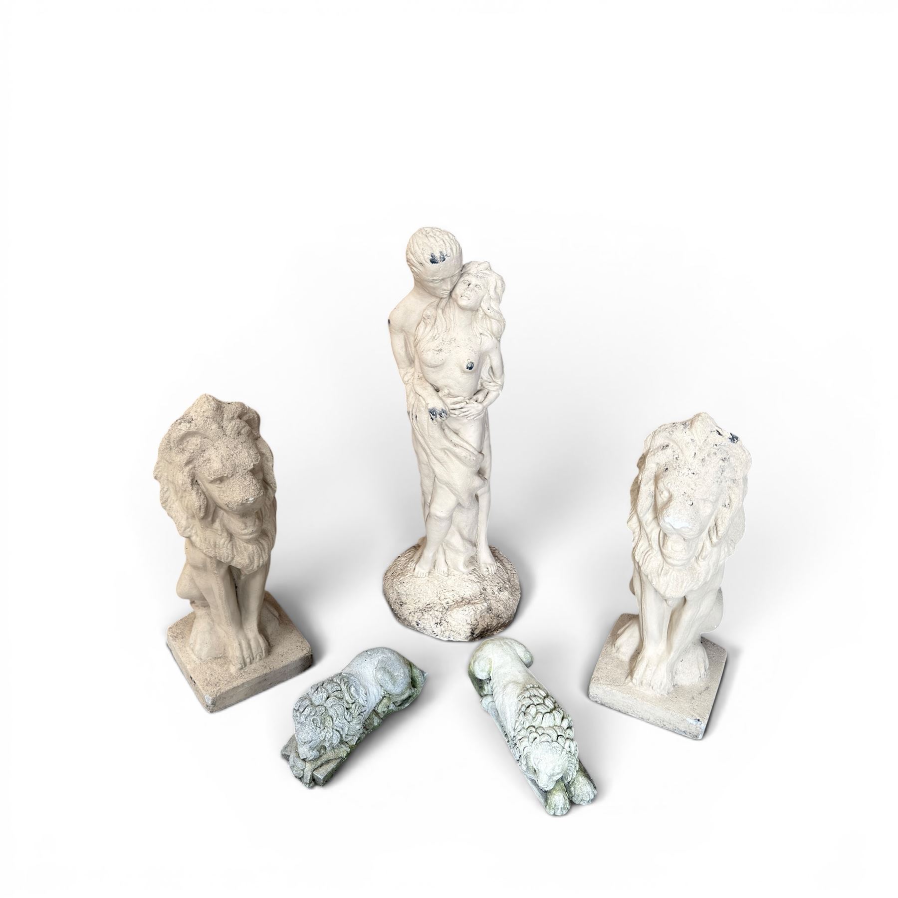 Pair of cast stone seat lions, male and female figure, and a miniature pair of cast stone lions