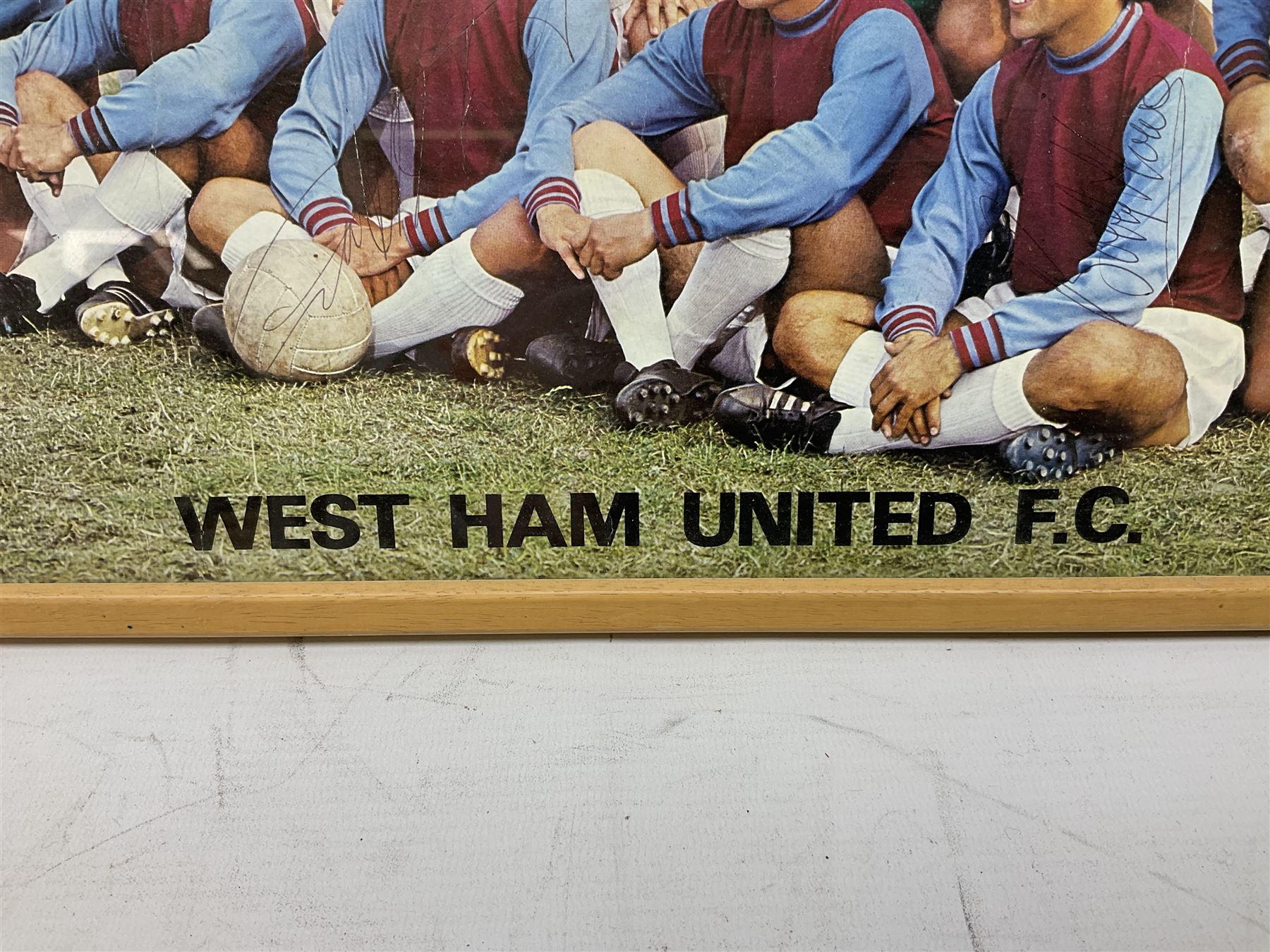 1970-1 photograph of West Ham United FC squad members, including Bobby Moore, Geoff Hurst, Harry Redknapp, Trevor Brooking, Jimmy Greaves, Billy Bonds etc, most players with signatures, 30 x 45cm, framed and glazed