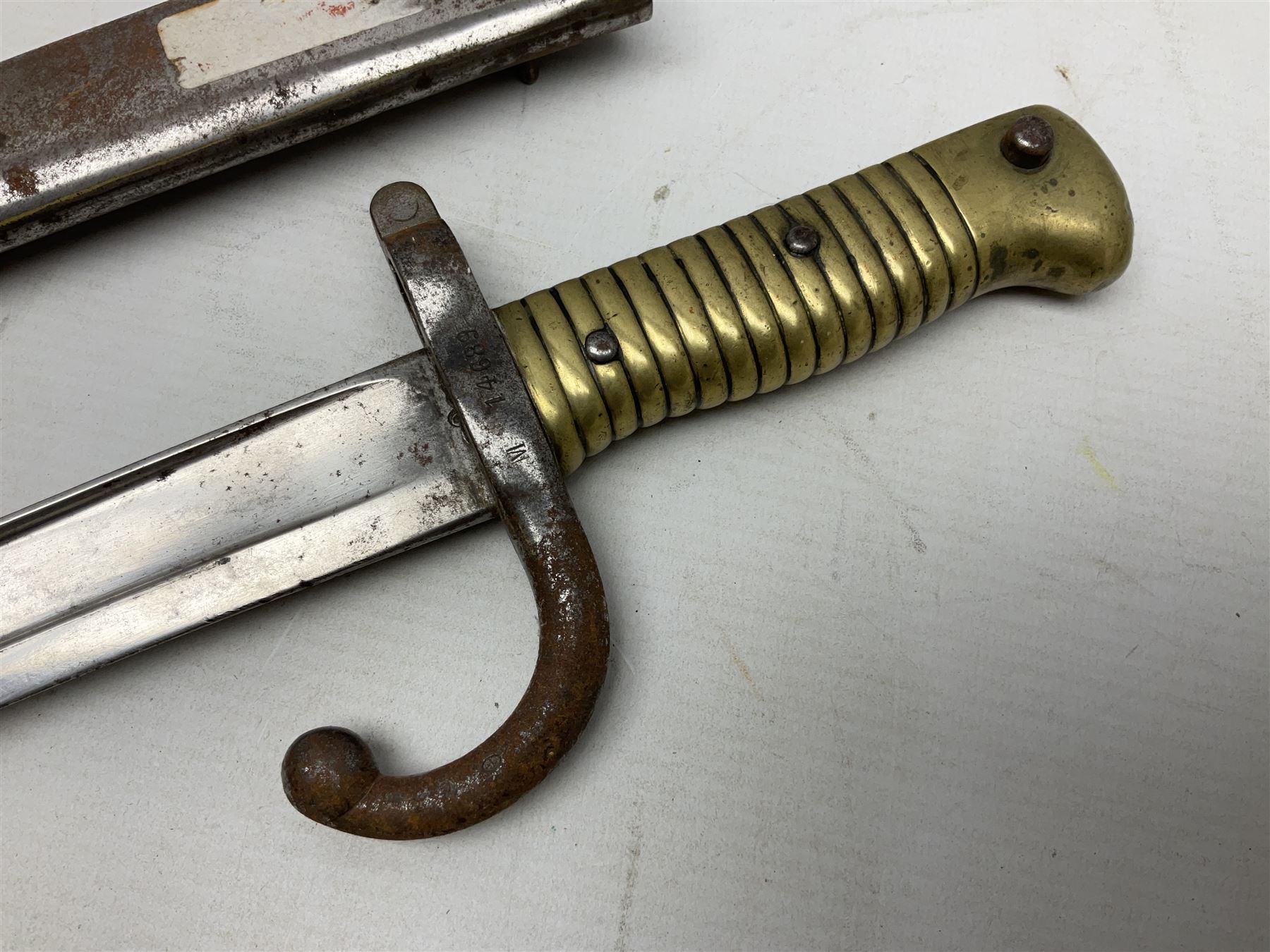 French model 1866 sabre bayonet, the 57.5cm curving blade marked St. Etienne 1873; in associated steel scabbard L71cm; and Mosin-Nagant M1891 socket bayonet with 43cm cruciform blade No.37068 (no scabbard) (2)