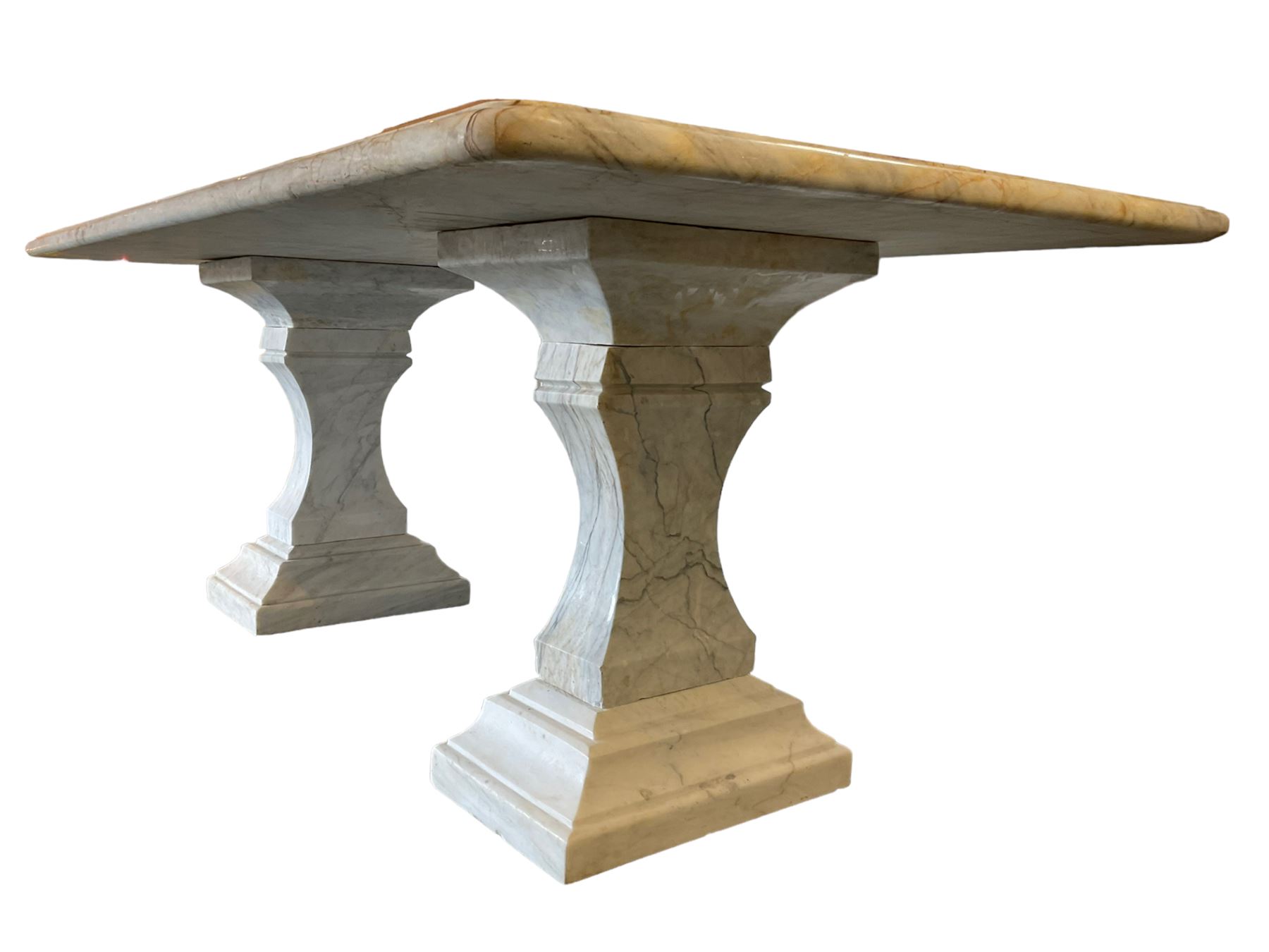 Classical Grecian design Carrera marble centre table, the rectangular single slab top with rounded corners and carved edge, raised on twin pedestals comprised of three pieces with a waisted column on a stepped plinth