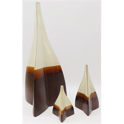  Set of three graduating ceramic vases, of triangular form with brown and white drip glaze, H64cm   