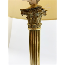 A brass Corinthian column table lamp, on stepped square base, including fitting H57cm, with pleated shade.
