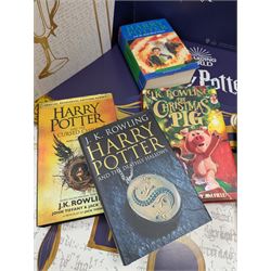 Eleven JK Rowling books, comprising six Harry Potter books, including four first editions, Fantastic Beasts screen play, Harry Potter and the Cursed Child, Tales of Beedle the Bard, Casual Vacancy first edition, Christmas Pig First edition and a Harry Potter card board back drop