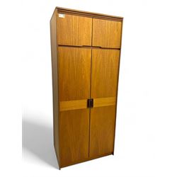 William Lawrence - mid-20th century teak double wardrobe, upper storage section over twin doors featuring recessed handles and contrasting horizontal panel, enclosing hanging rail compartment, towel rail, mirror, shelves and drawer, on plinth base with concealed castors