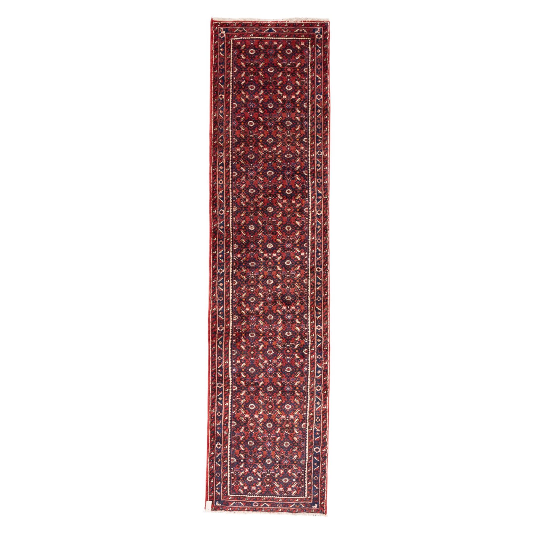 North West Persian Malayer hand-knotted runner, decorated with a dense all-over pattern of small repeating boteh and rosette motifs on a rich madder red ground, field filled with geometric floral elements arranged in a lattice design, framed by a narrow main border and flanked by slender guard borders, with cotton fringe ends 