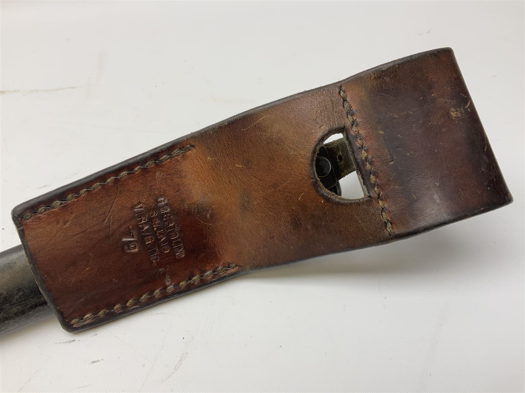 British Enfield 1907 model SMLE bayonet, with 43cm fullered steel blade and metal mounted leather scabbard L58cm overall; and Schmidt-Rubin Model 1918 bayonet the 30cm steel blade marked Elsener Schwyz No.579722; in steel scabbard with leather frog marked G. Bertolini Sellaio Vira/G.Tic 79 L45cm overall (2)