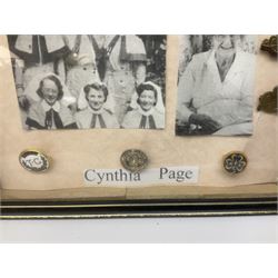 Framed display of medals and badges relating to Captain Cynthia Page of Queen Alexandra's Royal Army Nursing Corps including WW2 War Medal and Defence Medal with miniatures; Red Cross Society 3-Year Service Medal; Q.A.R.A.N.C. cap badge; Girl Guide and silver Scout badges; rank epaulettes; and related photographs 33 x 23cm