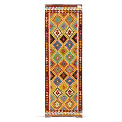 Afghan Chobi kilim flatweave runner with a repeating stepped diamond medallion design in l...