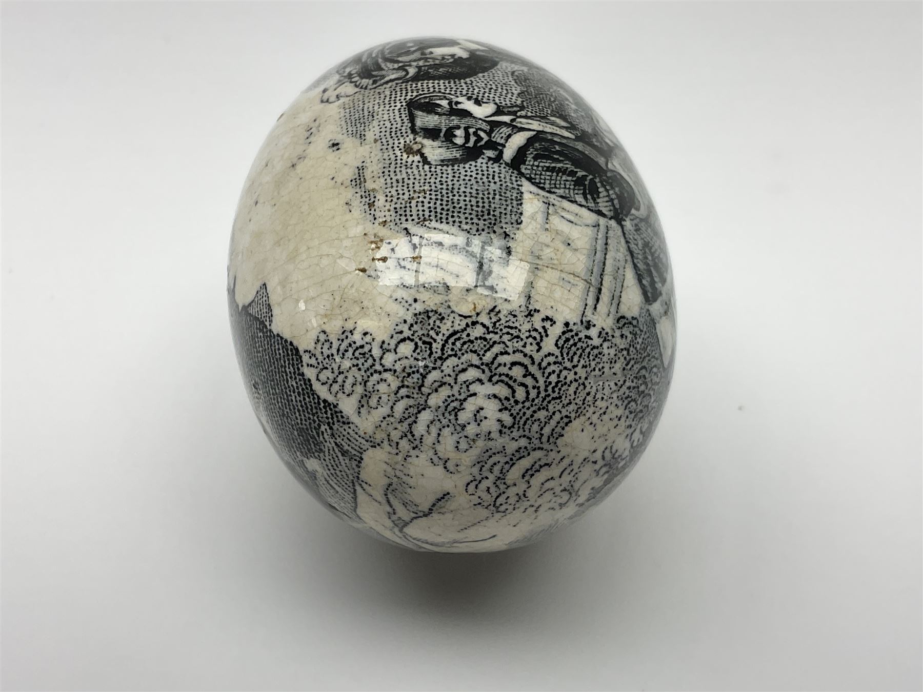 Victorian pottery egg transfer, printed with scenes 'Androcles and the lion' and a courting couple, L7cm 