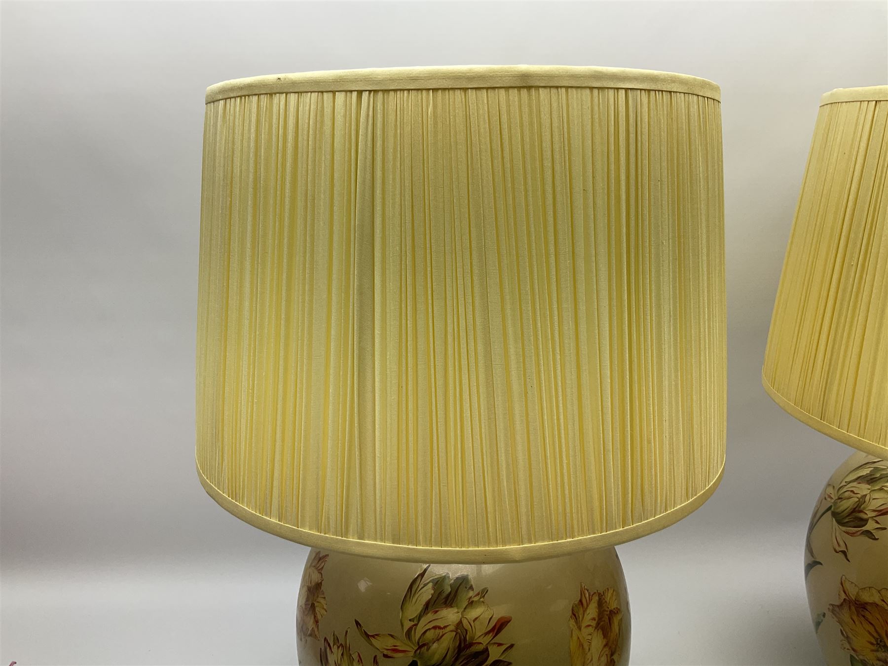 Pair of Potichomania tulip design glass table lamps, by Jenny Worrall, H40cm, with cream pleated lampshades. 