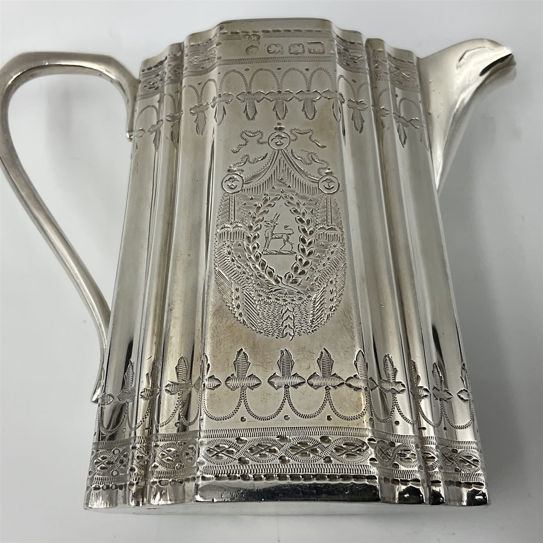 Victorian three-piece silver tea service, comprising teapot, twin handled open sucrier and milk jug, of oval form with shaped rim and C handles, each engraved with crests and bands of strapwork decoration, the milk jug and sucrier with gilt interiors, hallmarked Josiah Williams & Co, Exeter 1881, the teapot with ivory insulators and finial, all contained with a tooled leather, blue silk and velvet lined fitted case, retailed by West & Sun, Dublin 
This item has been registered for sale under Section 10 of the APHA Ivory Act