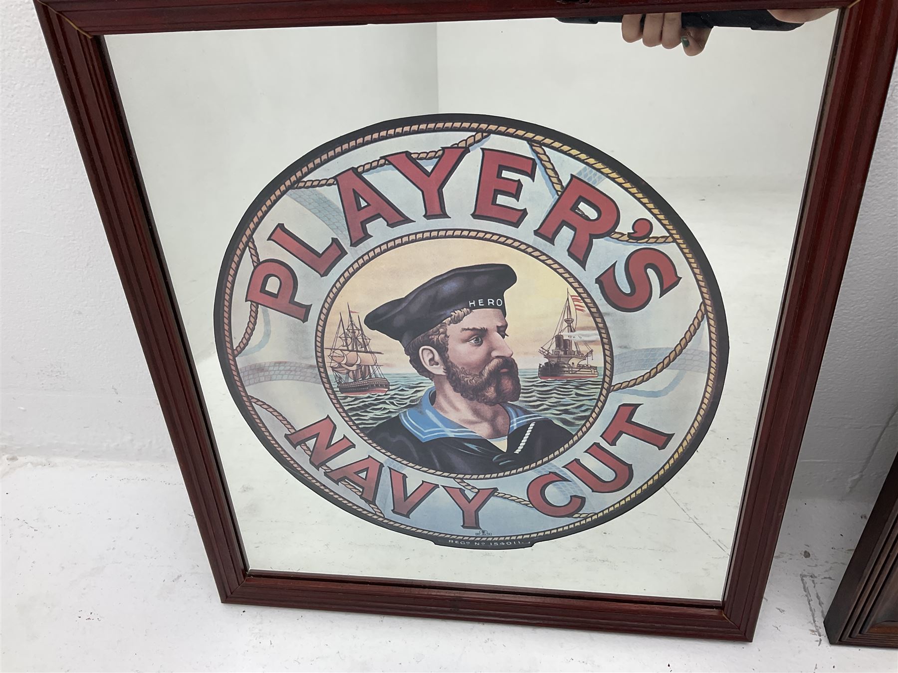 Four advertising mirrors, comprising of Southern Comfort, All Ranks smoke Marcella Cigars, Coca-Cola and Player's Navy Cut, largest example H70cm, L60.5cm