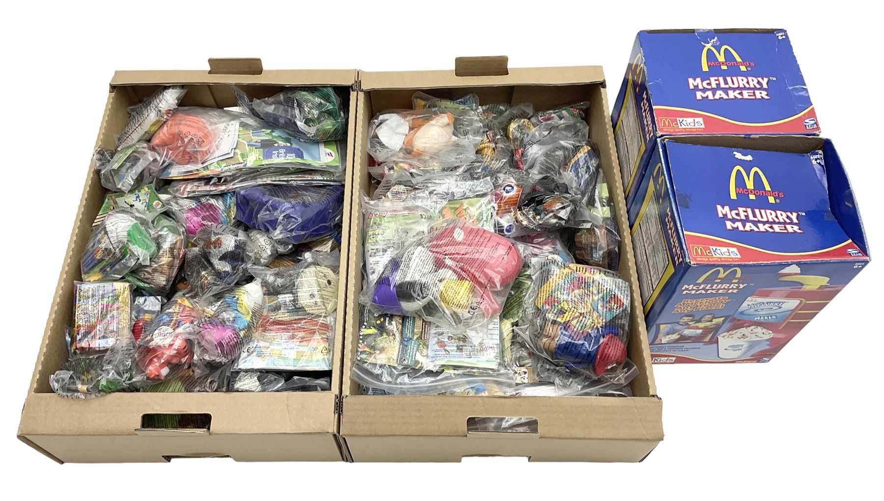 Quantity of Mcdonalds toys and two boxed Mcflurry makers in two boxes