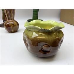 Linthorpe pottery vase with crimped rim and ovoid body, Linthorpe jug with high loop handle and crimped spout, a pair of candlesticks with a green, brown glaze and other similar pottery 