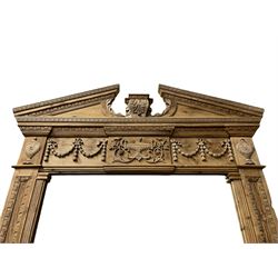 Large Adams design pine frame mirror, sloped broken arch pediment with central acanthus leaf carving, the frieze decorated with bell flower garlands and central kylix vase motif, large plain mirror plate flanked by panelled sides with egg and dart mouldings and reeded slip mouldings, on plinth base