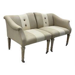 Pair of contemporary hardwood corner chairs, upholstered in broad alternating bands of neutral-toned fabric, each with two knotted rope buttons to the backrest, the whole raised on turned and lightly whitewashed supports terminating in castors