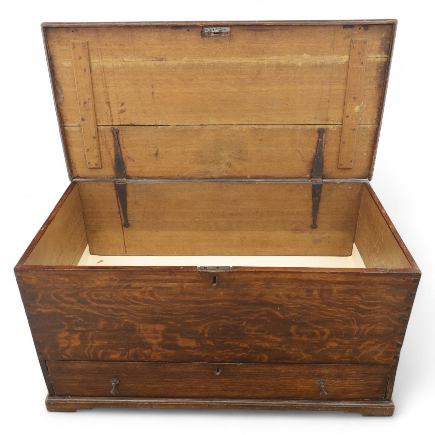 19th century oak blanket chest, rectangular hinged plank top with moulded edge, plain sides fitted with iron carrying handles, single full-width drawer to base with brass drop handles, on moulded plinth base