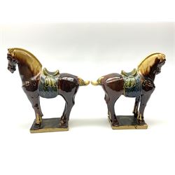 A pair of glazed pottery Tang style horses, each with impressed marks beneath, each approximately H25.5cm. 
