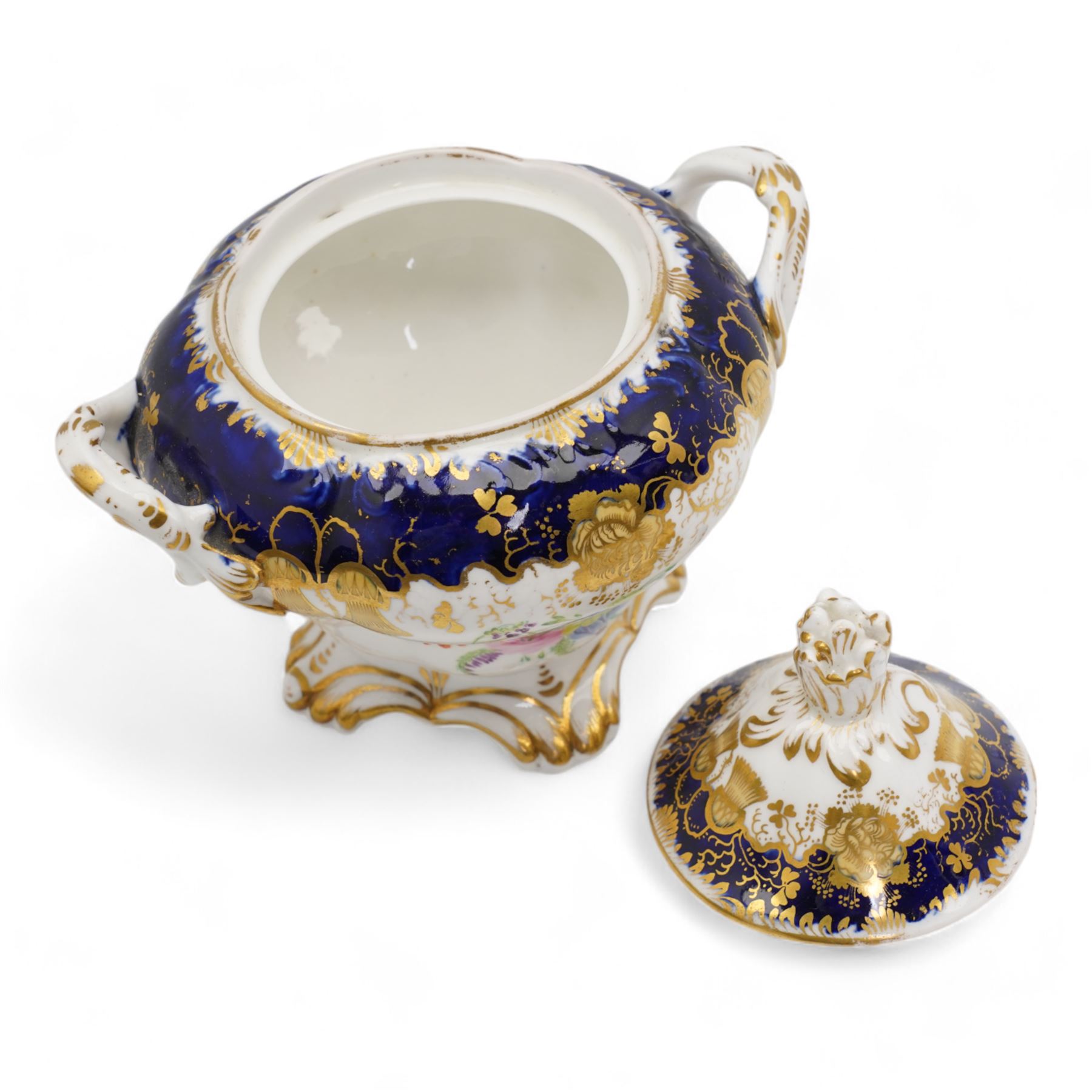19th century porcelain part tea service, probably Spode, comprising sucrier, milk jug, sandwich plate, seven cups and two saucers, decorated with floral sprays, within cobalt blue and gilt borders, pattern no. 735 