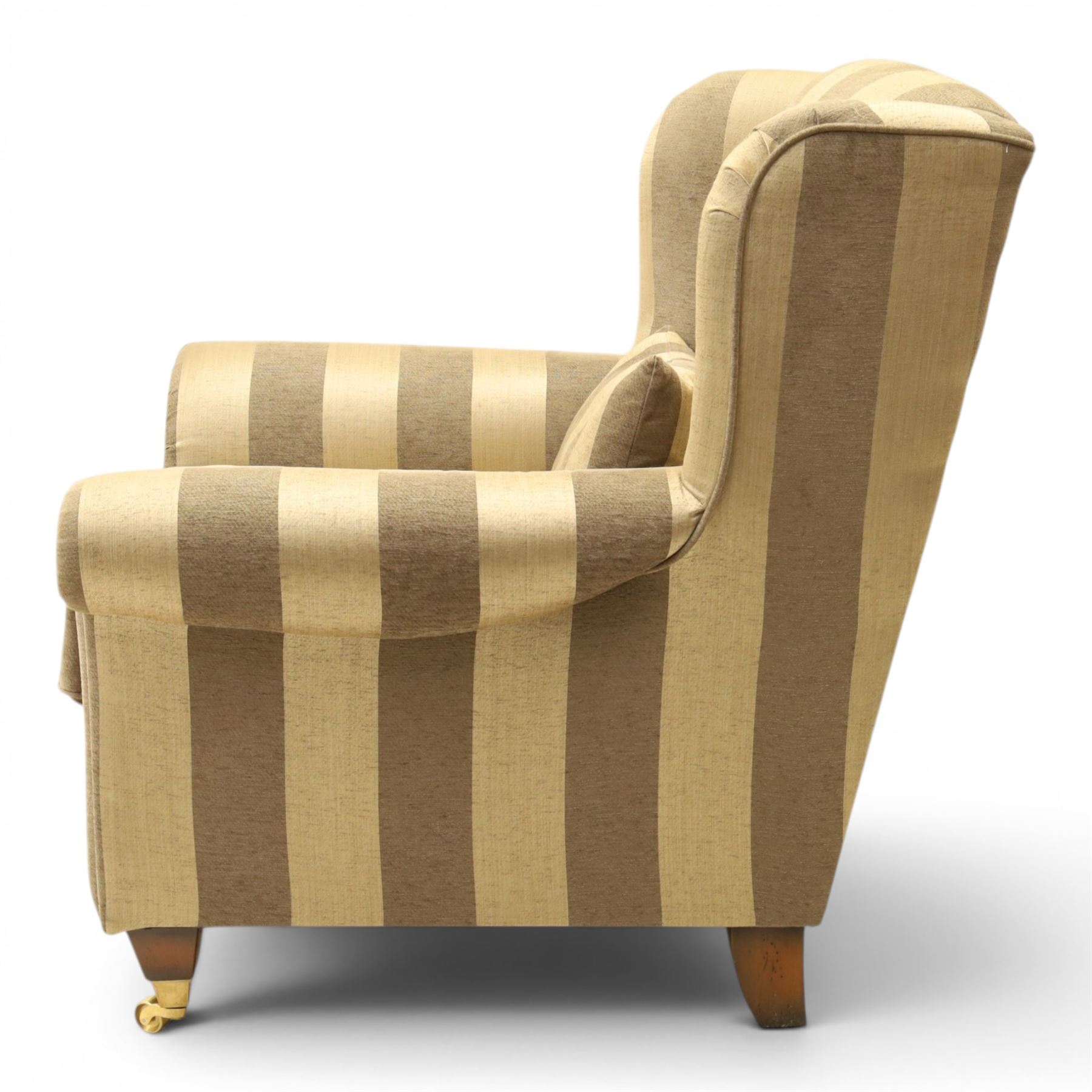 Alstons - 'Ixworth' armchair, upholstered in striped fabric, with loose seat cushions and scrolled arms, brass front castors