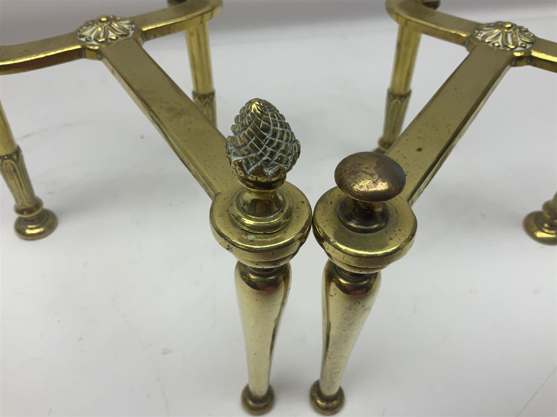 Early 20th century brass coal bucket with pierced sides, upon three pad feet, together with a pair of brass fire dogs, with flambe finials, coal bucket H27cm