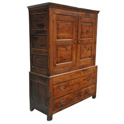 Georgian rustic oak housekeeper’s cupboard, moulded cornice above a pair of fielded panel cupboard doors enclosing a boarded interior with central divider and hanging hooks, the base fitted with two long drawers with brass swan neck handles, raised on stile supports