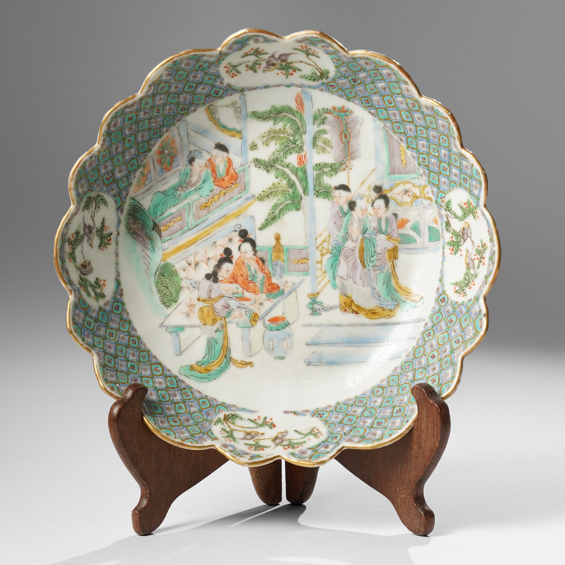 Chinese Kangxi period famille verte bowl, painted with seven figures in a pavilion interior, in Cantonese style border with foliate rim, the exterior painted with similar scenes, D24cm