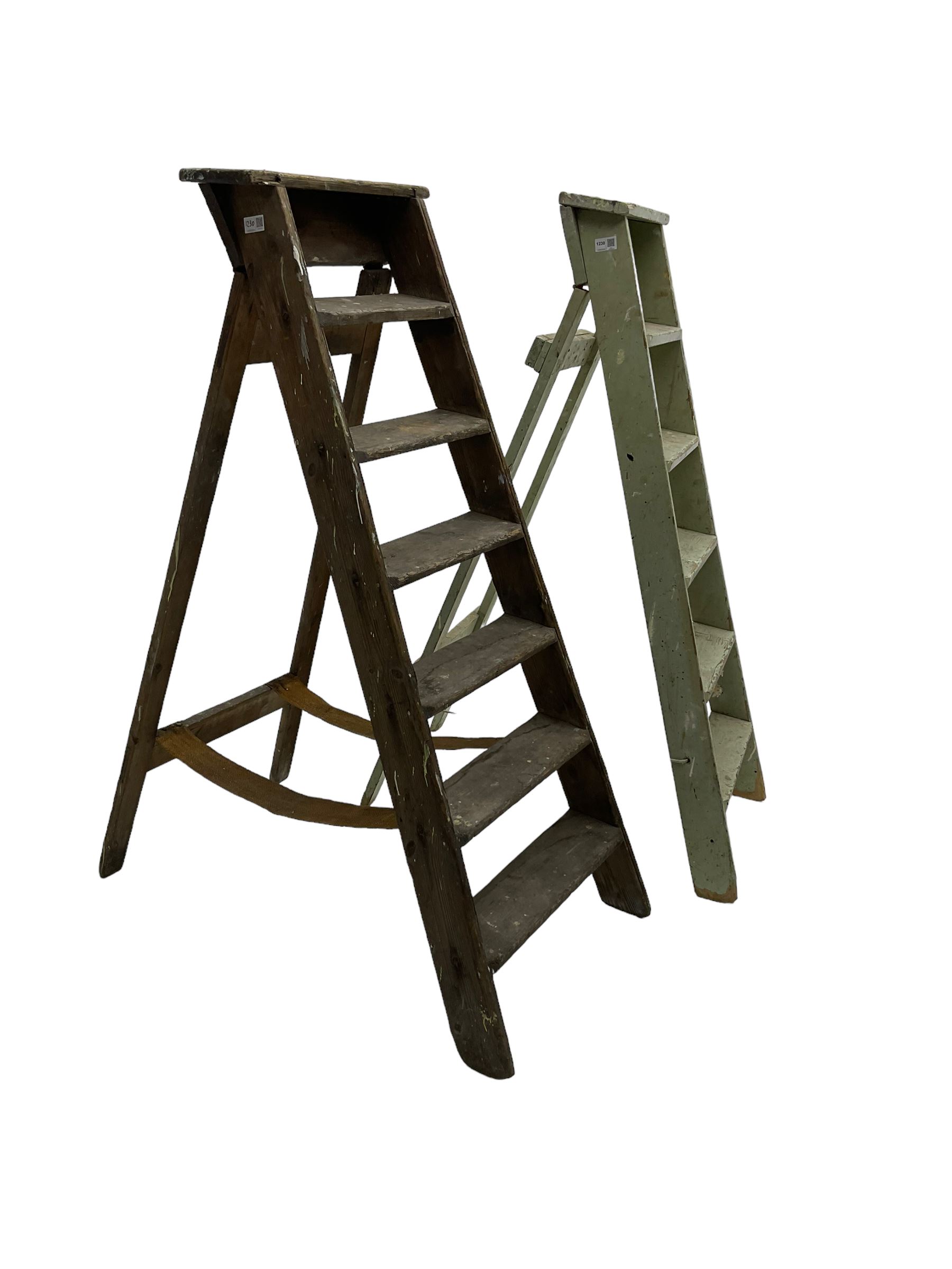 Early 20th century pine library or shop step ladder, seven tread (W45cm H135cm); together with another similar with painted laurel green finish (H135cm)