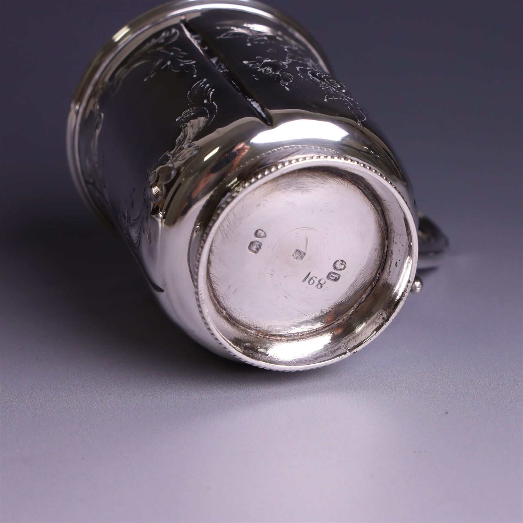 Victorian silver christerning mug, of cylindrical form with four panels of embossed floral decoration, hallmarked H J Lias & Son, London 1876, H10cm