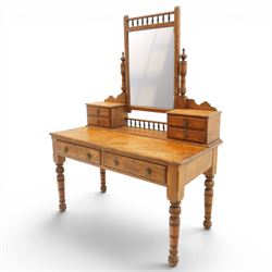Victorian stripped pine dressing table, rectangular top over two drawers with brass handles, the raised back fitted with adjustable rectangular mirror, spindle gallery flanked by two short jewellery drawers either side, on turned legs