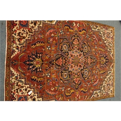  Persian Meshed carpet, large central stylised medallion on red field, decorated with flowers and foliage, 265cm x 286cm  