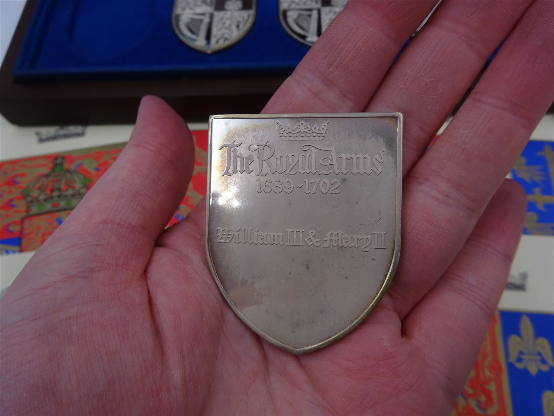 Yorkshire Mint, The Royal Arms Collection, twelve shield shaped silver medallions each depicting variations on the Royal coat of arms, each hallmarked Yorkshire Mint, Birmingham 1976/77, contained within fitted wooden case with associated information cards