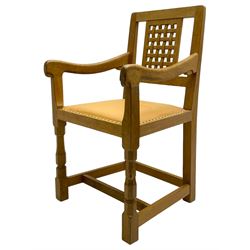  Mouseman - oak carver elbow chair, pierced and carved lattice back over leather upholstered seat with stud band, on octagonal supports united by plain stretchers, carved with mouse signature, by the workshop of Robert Thompson, Kilburn 