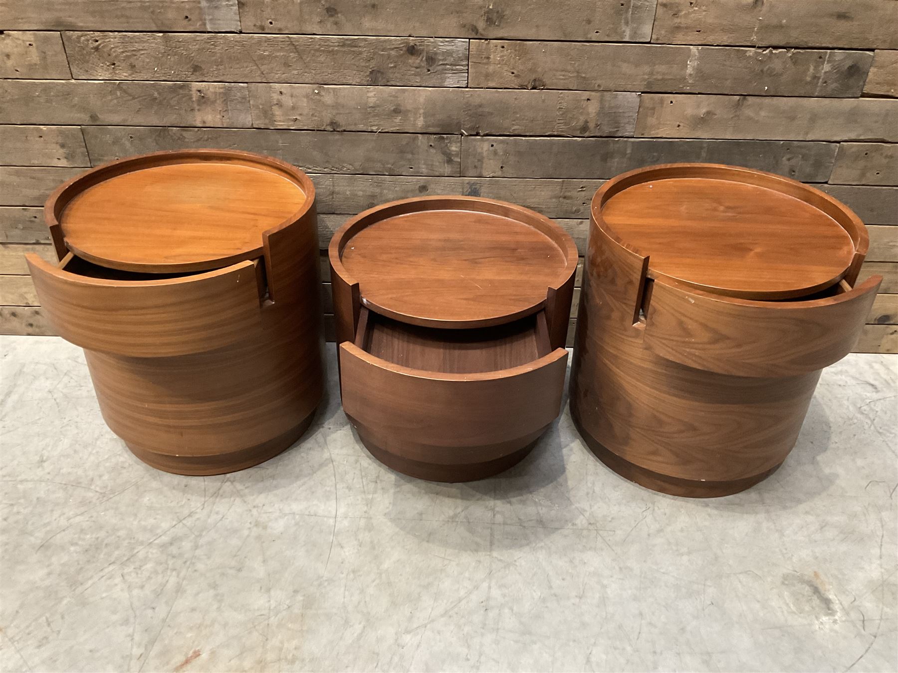 Three walnut circular barrel shaped lamp tables, fitted with single drawer (lower table D53cm, H49cm)
