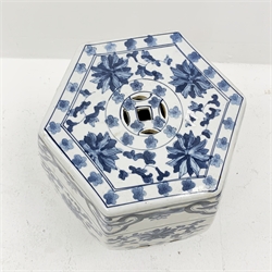 A Chinese blue and white garden seat, of hexagonal barrel form, decorated with stylised flowers, H48cm.