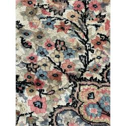 Persian design ivory and pink ground rug, the field decorated with central rosette medallion surrounded by trailing branches and flower heads, repeating border within guard stripes 