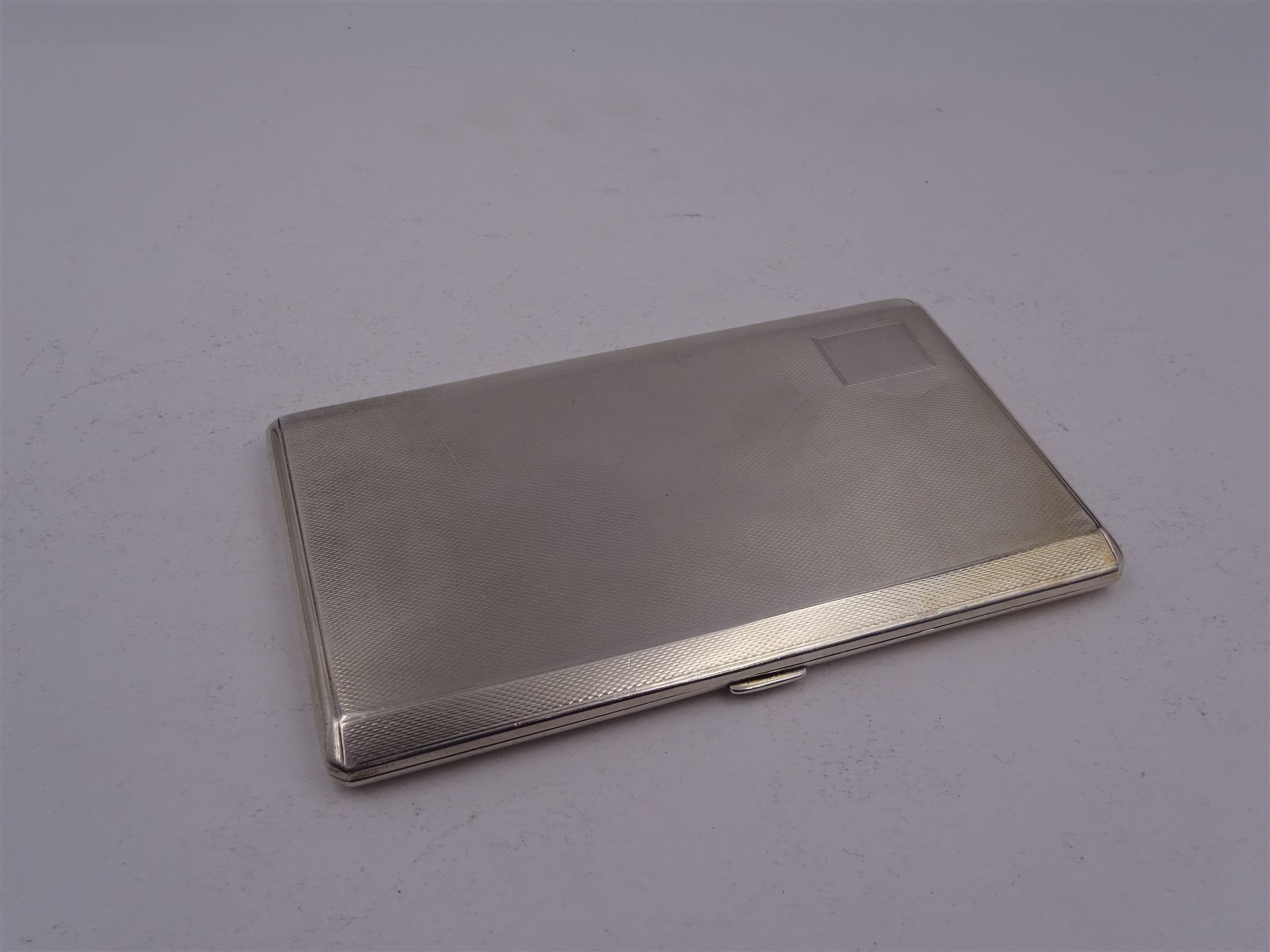 1920s silver cigarette case, of rectangular form, with engine turned decoration and blank cartouche, hallmarked John Henry Wynn, Birmingham 1921, H14cm
