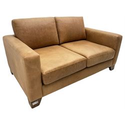 20th century two seat sofa, upholstered in tan leather with loose back and seat cushions, on stained beech tapering feet, with scatter cushions