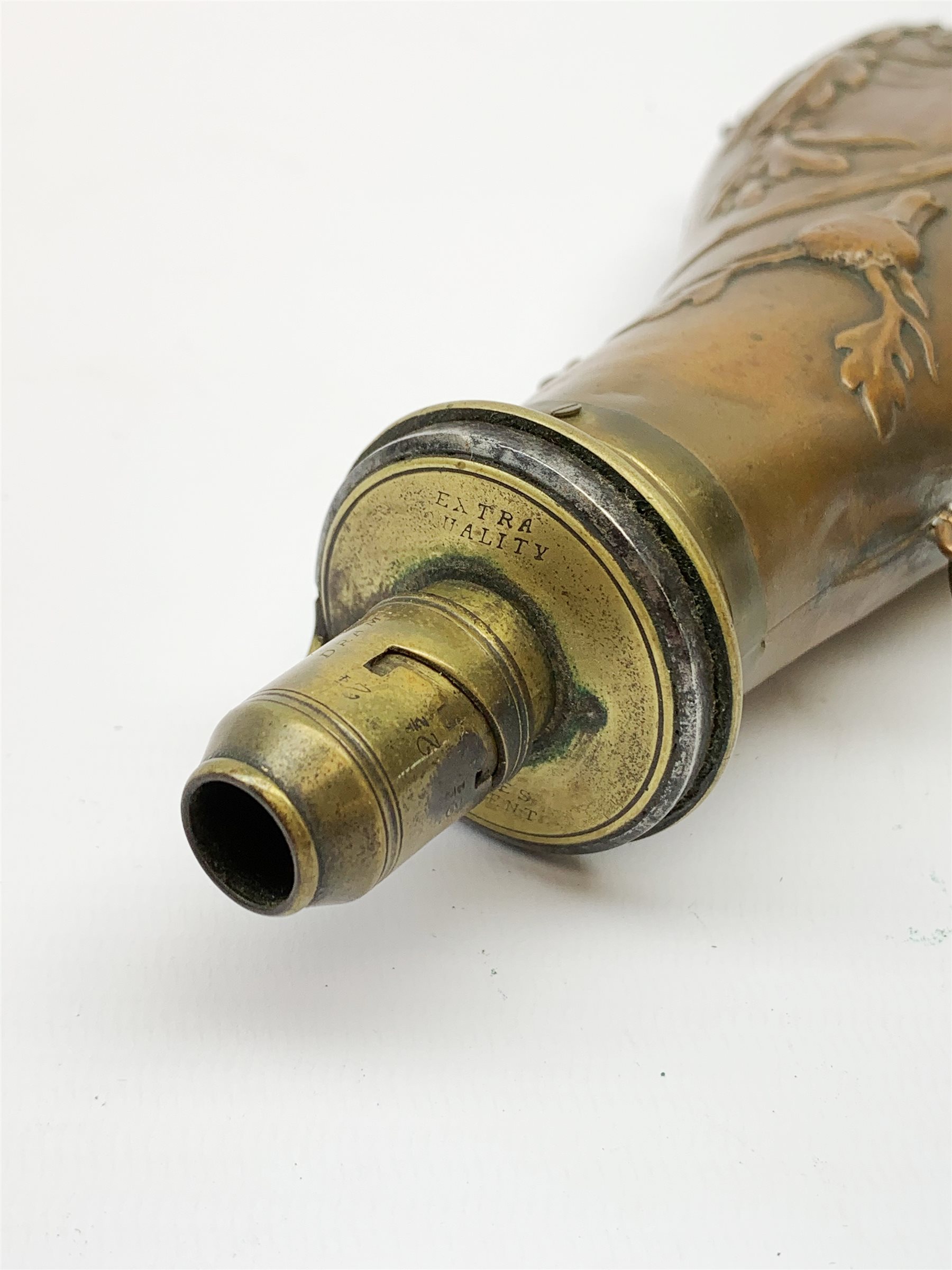 Victorian large copper powder flask embossed with a hunting scene within an oak leaf border with stag and fox heads, the nozzle marked 'Extra Quality Sykes Patent', fitted with four suspension rings H24cm; together with Victorian leather shoulder shot flask with Sykes nozzle L80cm (2)
